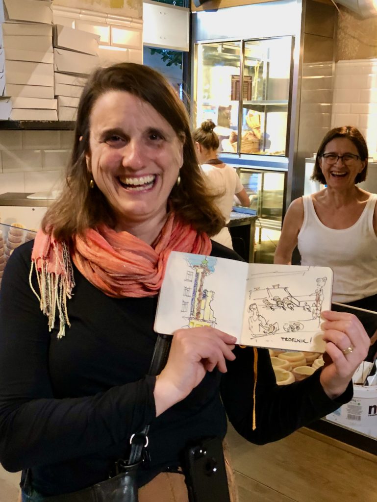 Kristin Pennock showing sketch of Trdelník baker - Prague